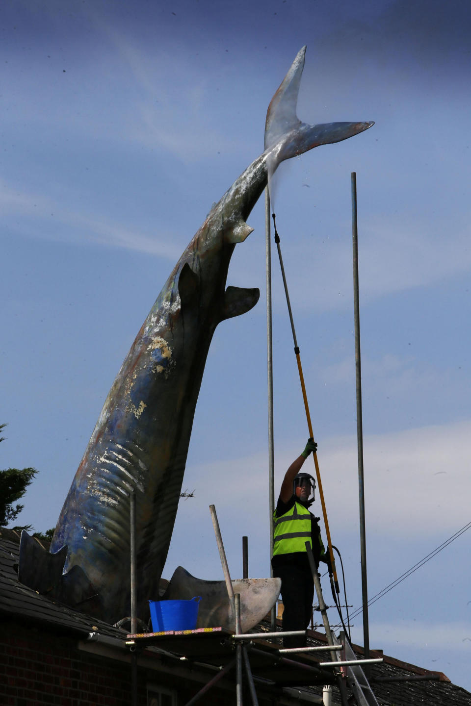 Workers restoring the world-famous Headington Shark. (SWNS)