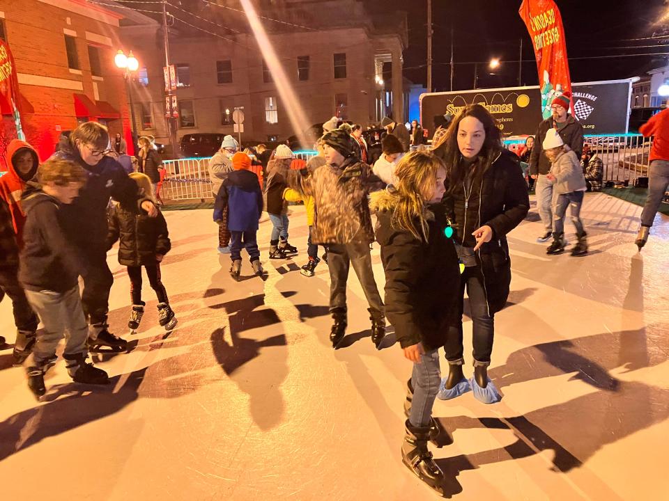 Lauren Miller and her daughter Leah, 9, on skating rink sponsored by the FCBank. Adam Moore from SuperGames who helped distribute the skates at the event said they distributed around 300 to 350 pairs that evening, which was about the same as the previous year. The average skating time was 15 minutes, said Moore.