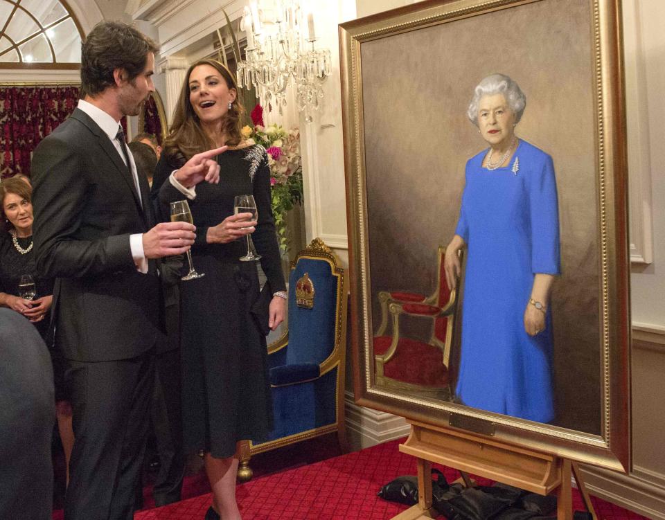 Britain's Catherine, Duchess of Cambridge speaks to artist Nick Cuthell after she and her husband Prince William unveiled Cuthell's portrait of Britain's Queen Elizabeth at state reception at Government House in Wellington