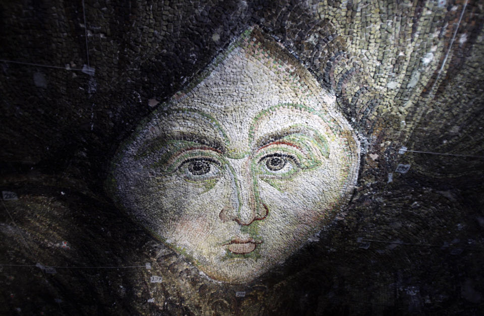 FILE - A well-preserved, long-hidden mosaic depicting the face of an angel which was uncovered by restoration workers at the former Byzantine cathedral of Haghia Sophia in Istanbul, Turkey, is seen on Saturday, July 25, 2009. The seraphim figure _ one of two located on the side of a dome _ had been covered up along with the building's other Christian mosaics shortly after Constantinople _ the former name for Istanbul _ fell to the Ottoman Turks in 1453 and the cathedral was turned into a mosque. The mosaics were plastered over according to Muslim custom that prohibits the representation of humans. (AP Photo/Ibrahim Usta, File)