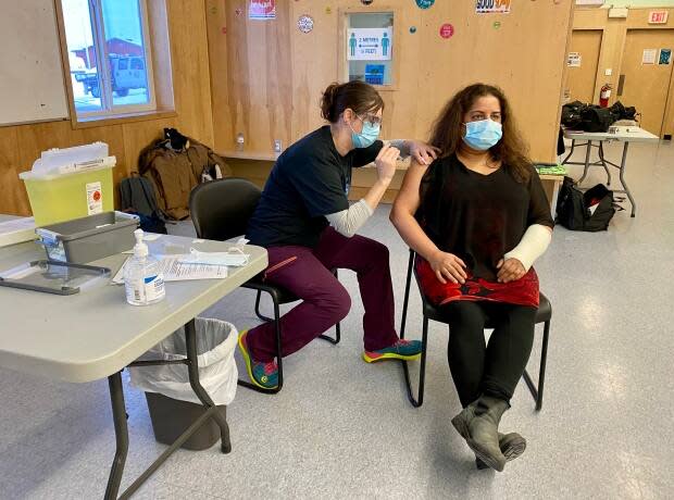 Chief Public Health Officer Dr. Kami Kandola receives her first dose of the Moderna COVID-19 vaccine on Jan. 13 in Wekweètì. Health authorities now say 75 per cent of adults must be vaccinated before many health restrictions are eased.