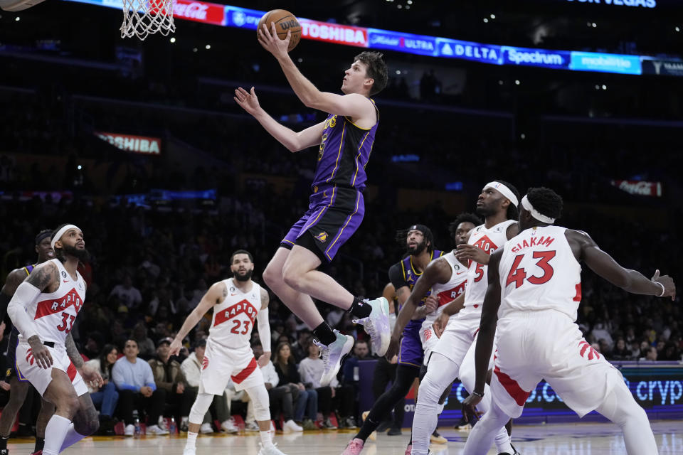 Los Angeles Lakers guard Austin Reaves, top center, drives to the basket against the Toronto Raptors during the first half of an NBA basketball game Friday, March 10, 2023, in Los Angeles. (AP Photo/Marcio Jose Sanchez)