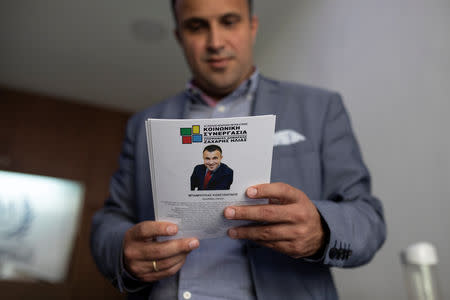 Undertaker and candidate for town councillor at the municipality of Sykies, Konstantinos Baboulas, holds a pre-election leaflet at his family's funeral parlor in Thessaloniki, Greece, May 17, 2019. Picture taken May 17, 2019. REUTERS/Alkis Konstantinidis