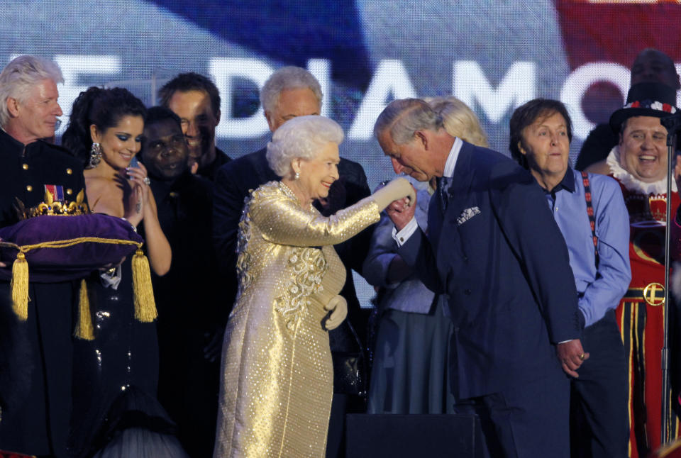 FILE - In this Monday, June 4, 2012 file photo, Prince Charles gestures to his mother, Britain's Queen Elizabeth II, at the end of the Queen's Jubilee Concert in front of Buckingham Palace, London. The concert is a part of four days of celebrations to mark the 60 year reign of Britain's Queen Elizabeth II. Queen Elizabeth II, Britain’s longest-reigning monarch and a rock of stability across much of a turbulent century, has died. She was 96. Buckingham Palace made the announcement in a statement on Thursday Sept. 8, 2022. (AP Photo/Joel Ryan, File)