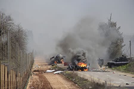 Burning vehicles are seen near the village of Ghajar on Israel's border with Lebanon, January 28, 2015. A Hezbollah missile strike wounded four Israeli soldiers on Wednesday, the biggest attack on Israeli forces by the Lebanese guerrilla group since a 34-day war in 2006. REUTERS/Maruf Khatib