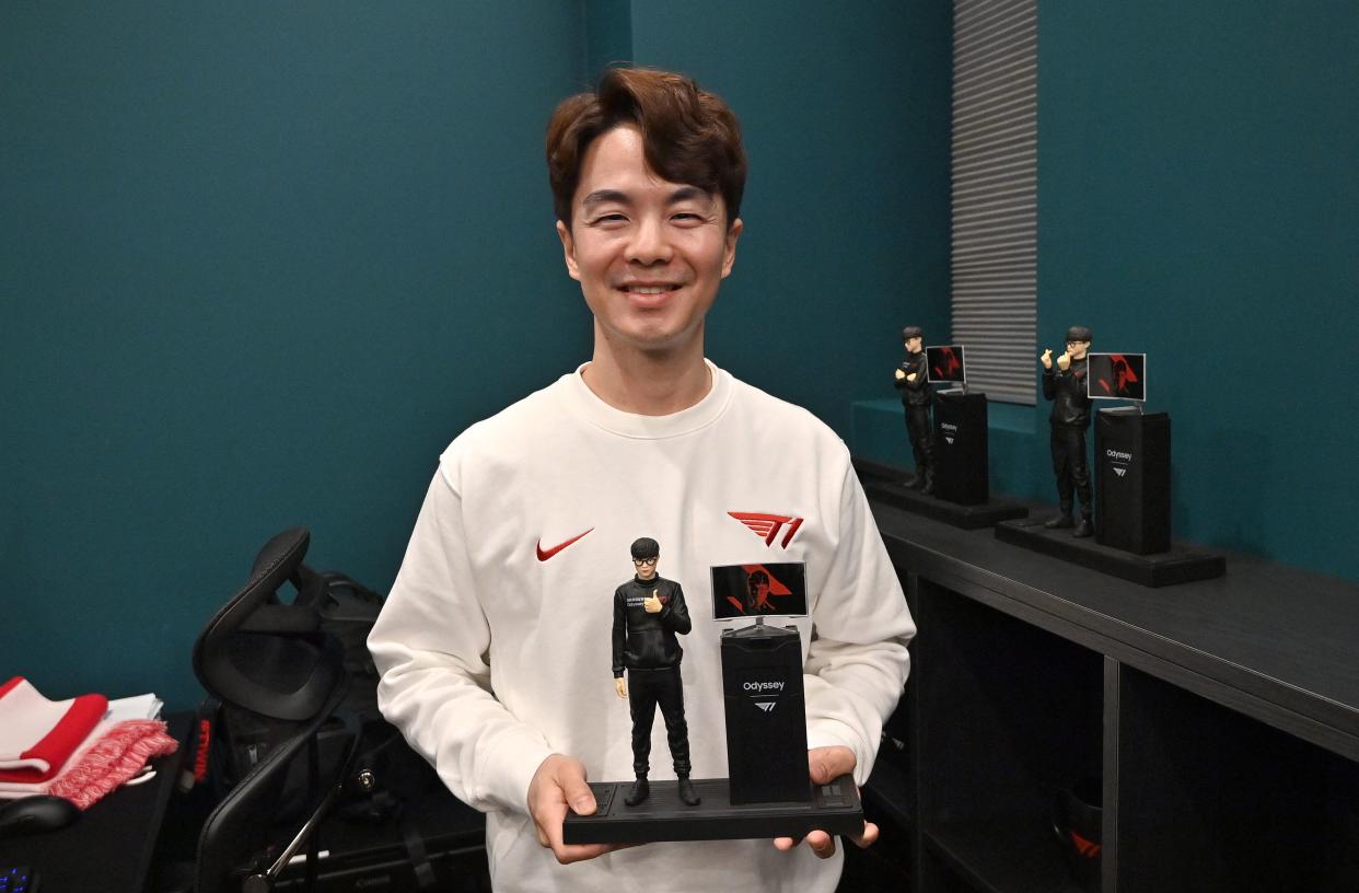 This picture taken on February 25, 2021 shows John Kim, chief operating officer of eSports organisation T1, posing with a figure of League of Legends giant Faker, during an interview with AFP at the T1 building in Seoul. - A Nike-sponsored gym, support staff including nutritionists, and English language classes are all part of the set-up at T1 where around 70 gamers are looking to emulate its highest-profile member, League of Legends giant Faker. - TO GO WITH AFP STORY SKOREA-ESPORTS-TECHNOLOGY-GAME-BUSINESS,FOCUS BY SUNGHEE HWANG (Photo by Jung Yeon-je / AFP) / TO GO WITH AFP STORY SKOREA-ESPORTS-TECHNOLOGY-GAME-BUSINESS,FOCUS BY SUNGHEE HWANG (Photo by JUNG YEON-JE/AFP via Getty Images)
