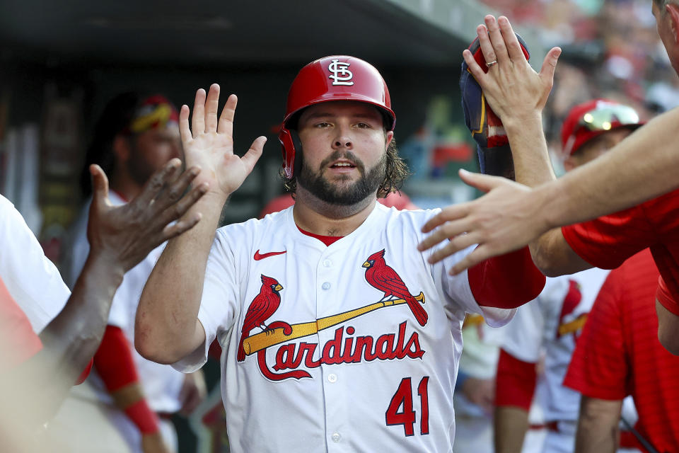 St. Louis Cardinals' Alec Burleson is congratulated by teammates after scoring during the third inning of a baseball game against the Atlanta Braves, Monday, June 24, 2024, in St. Louis. (AP Photo/Scott Kane)