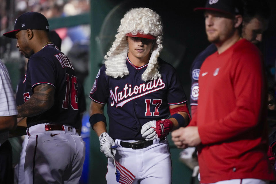 Washington Nationals' Alex Call walks through the dugout with a home-run wig after his solo home run against the Atlanta Braves during the third inning of a baseball game at Nationals Park, Thursday, Sept. 21, 2023, in Washington. (AP Photo/Andrew Harnik)