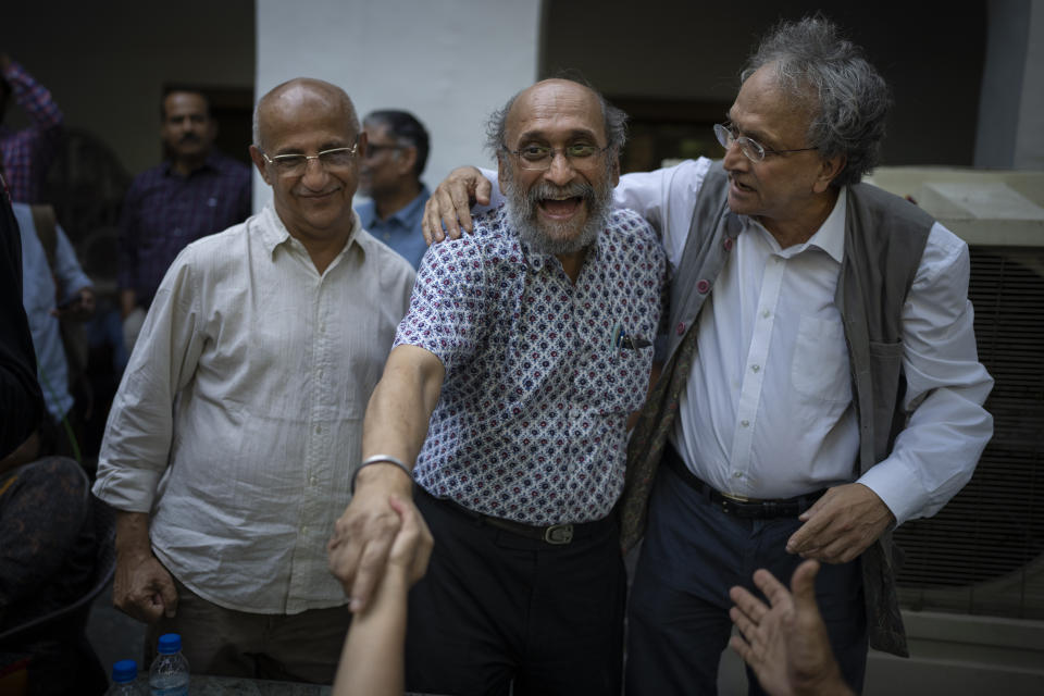 Paranjoy Guha Thakurta, center, a senior journalist and columnist associated with NewsClick, who was one of the 46 people detained by Delhi police Tuesday, is flanked by Harsh Mander, left, human rights activist and Ramchandra Guha, right, a historian, as he meets other journalists during a protest at press club of India in New Delhi, India, Wednesday, Oct. 4, 2023. Police in New Delhi on Tuesday arrested the editor of a news website and one of its administrators after raiding the homes of journalists working for the site, which has been critical of Prime Minister Narendra Modi and his Hindu nationalist-led government. (AP Photo/Altaf Qadri)