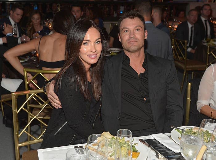 Megan and Brian smile for the camera at their table during an event