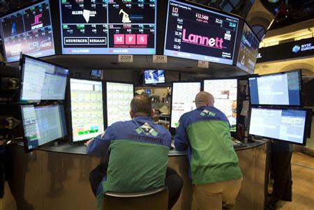 Traders work on the floor of the New York Stock Exchange at the opening bell in New York, January 2, 2014. REUTERS/Carlo Allegri