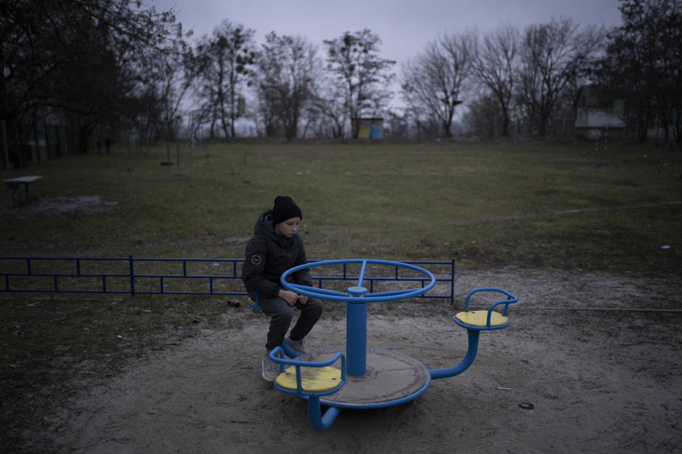 Anastasiia Okhrimenko's son, Vanya, plays at a playground in Bucha, Ukraine, Tuesday, Jan. 24, 2023. As the conflict that killed their loved ones still rages on, Anastasiia and her son, Vanya wrestle with a question that all of war-torn Ukraine must grapple with: After loss, what comes next? (AP Photo/Daniel Cole)