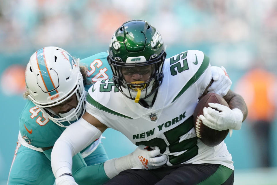 Miami Dolphins linebacker Duke Riley (45) tackles New York Jets running back Ty Johnson (25) during the first half of an NFL football game, Sunday, Jan. 8, 2023, in Miami Gardens, Fla. (AP Photo/Rebecca Blackwell)