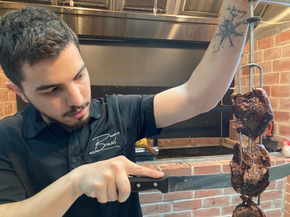 Victor Marques, co-owner of Made in Brazil, cuts picanha (a typically Brazilian cut of steak) at the Barre restaurant on April 22, 2022.