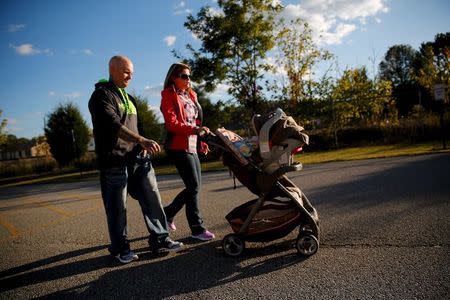 Donnie Gooding and Katy Yeager Gooding walk with their baby Kennedy Gooding in Barboursville, West Virginia, October 18, 2015. REUTERS/Jonathan Ernst