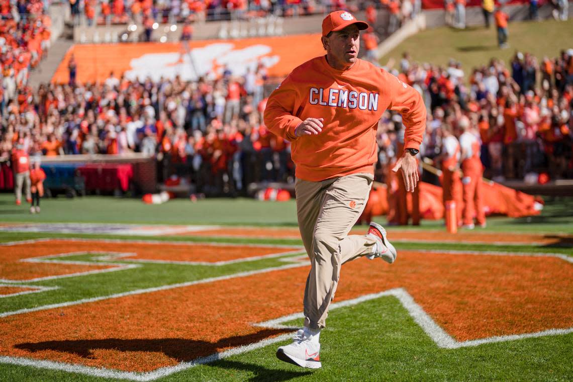 Clemson head coach Dabo Swinney runs onto the field before an NCAA college football game against Syracuse on Saturday, Oct. 22, 2022, in Clemson, S.C. (AP Photo/Jacob Kupferman)