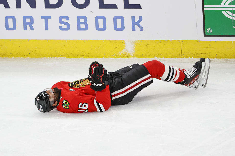 Chicago Blackhawks center Jujhar Khaira (16) lays on the ice after being knocked out by New York Rangers defenseman Jacob Trouba during the second period of an NHL hockey game, Tuesday, Dec. 7, 2021, in Chicago. (AP Photo/Kamil Krzaczynski)