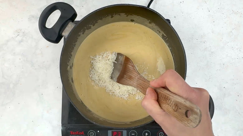 stirring Parmesan in soup