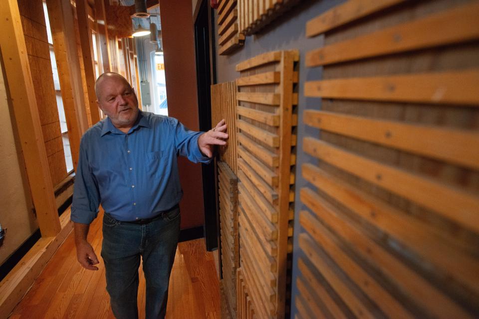 Parts of the original printer trays from master plates used in the Thacher Building during a time it was a print shop are shown by building owner Jeff Carson recently. On the opposite wall are repairs done to deal with structural issues in the historic building.