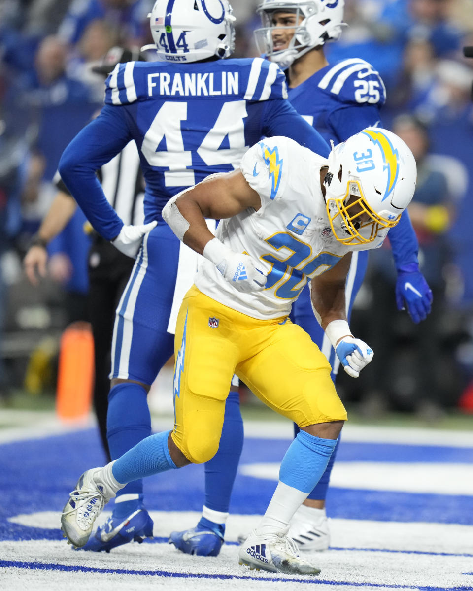 Los Angeles Chargers' Austin Ekeler (30) celebrates a touchdown run during the second half of an NFL football game against the Indianapolis Colts, Monday, Dec. 26, 2022, in Indianapolis. (AP Photo/Michael Conroy)