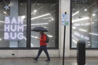 FILE PHOTO: A man walks past a shop window with a Christmas theme amid the coronavirus disease (COVID-19) outbreak in London