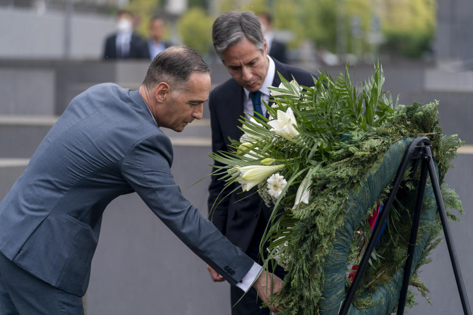 U.S. Secretary of State Antony Blinken, right, and German Minister of Foreign Affairs Heiko Maas, left, touch a wreath during a ceremony for the launch of a U.S.-Germany Dialogue on Holocaust Issues at the Memorial to the Murdered Jews of Europe in Berlin, Thursday, June 24, 2021. Blinken is on a week long trip in Europe traveling to Germany, France and Italy. (AP Photo/Andrew Harnik, Pool)