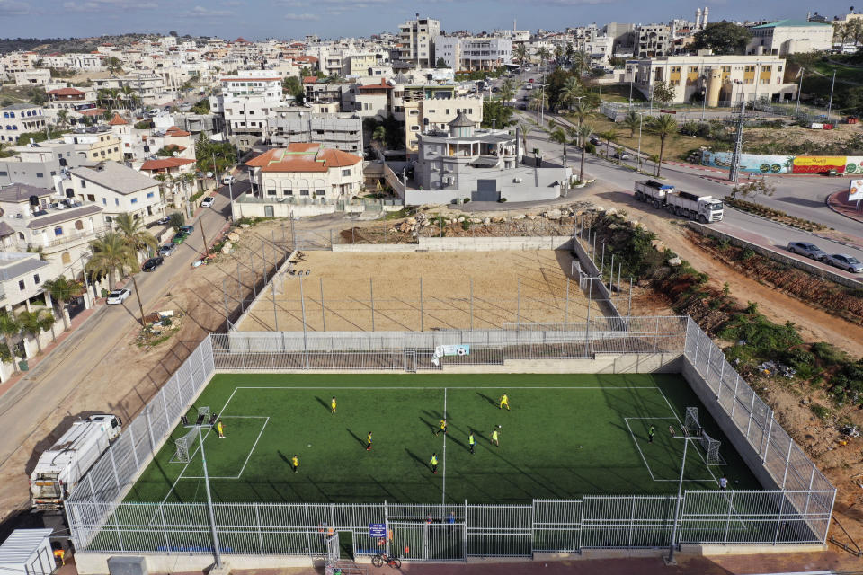 In this Thursday, Feb. 6, 2020, photo, Israeli Arab youths play soccer at the Israeli Arab town Kfar Qassem. President Donald Trump's Mideast initiative suggests that the densely populated Arab region of Israel could be added to a future Palestinian state, if both sides agree. The proposal has infuriated many of Israel's Arab citizens, who view it as a form of forced transfer. (AP Photo/Oded Balilty)