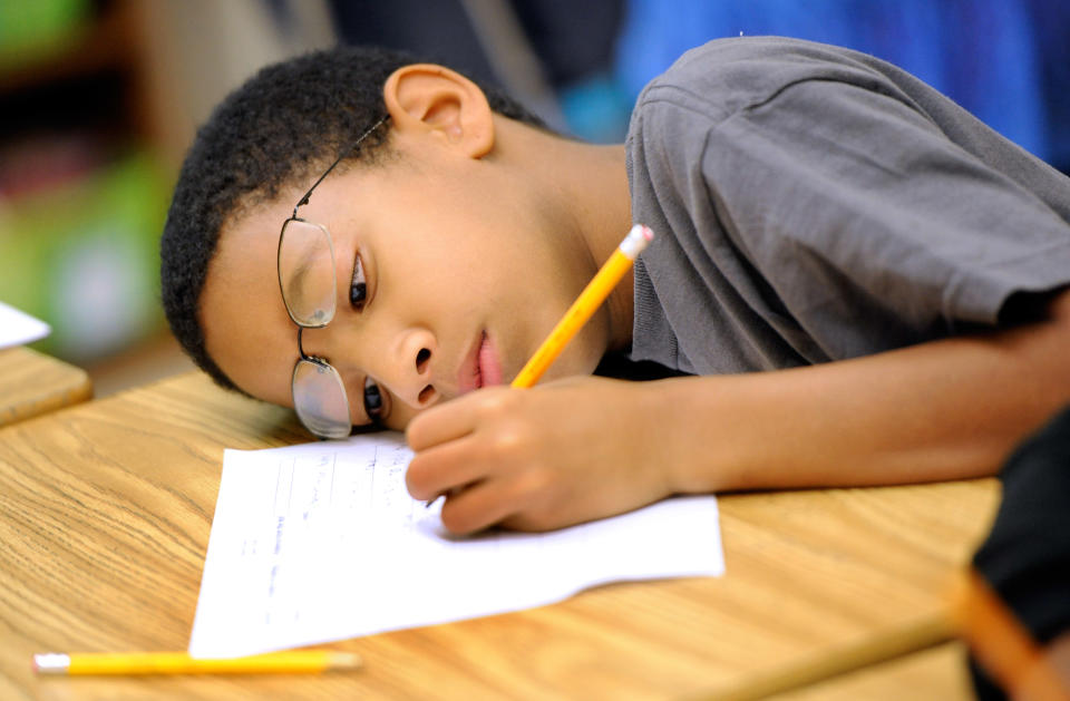 Jelani Guzman, a fifth-grader at Silver Lake Elementary School in Middletown, Del., works on an English language arts lesson at school Tuesday, Oct. 1, 2013. Silver Lake has begun implementing the national Common Core State Standards for academics. Remembering the plot of a short story is no longer good enough. Now, students are being asked to think more critically -- what, for example, might a character say in an email to a friend. Welcome to a classroom using the Common Core State Standards, one of the most politicized and misunderstood changes in education for students and their teachers in grades kindergarten through high school. (AP Photo/Steve Ruark)