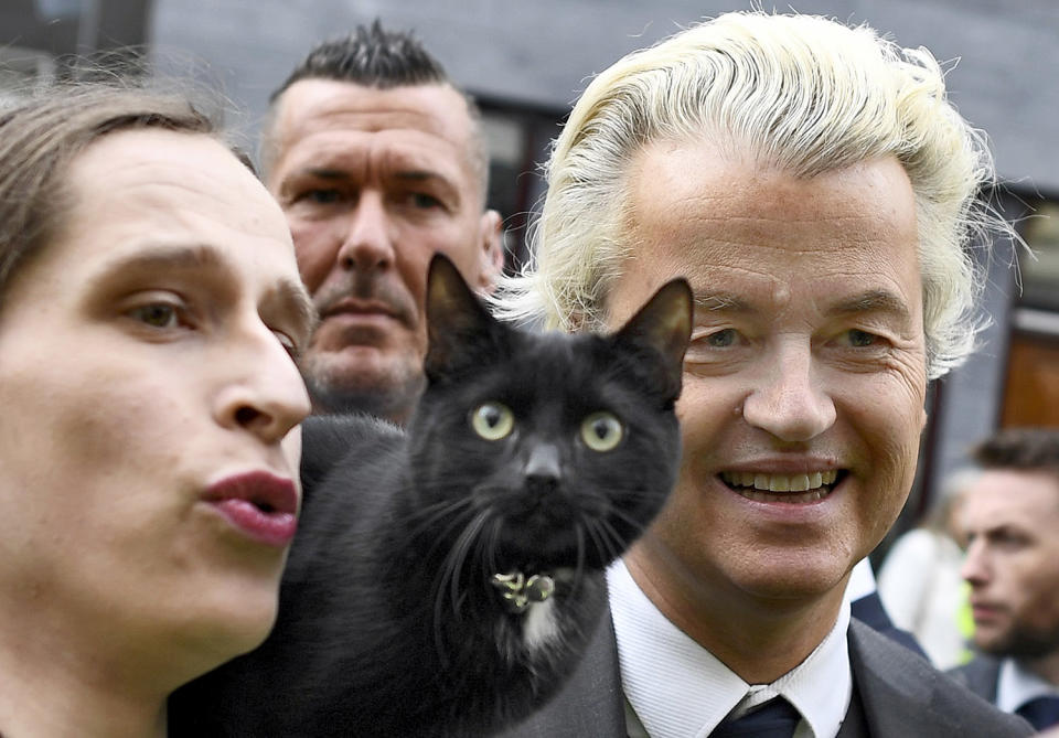 Geert Wilders poses with woman and a cat as he campaigns