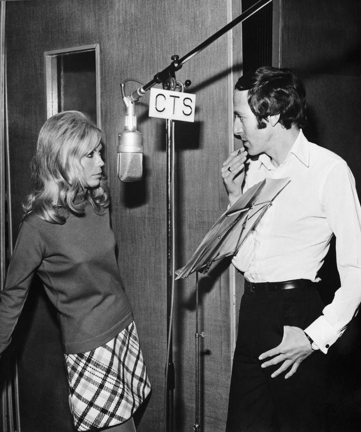 Nancy Sinatra with composer/conductor John Barry as they prepare to record You Only Live Twice. (Getty)