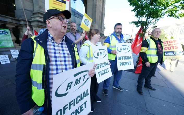 RMT union members are pictured outside Newcastle Station this morning - Owen Humphreys/PA