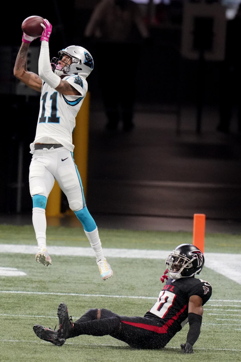 Carolina Panthers wide receiver Robby Anderson (11) makes the catch over Atlanta Falcons defensive back Kendall Sheffield (20) during the first half of an NFL football game, Sunday, Oct. 11, 2020, in Atlanta. Sheffield was injured on the play. (AP Photo/Brynn Anderson)