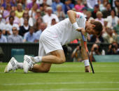 Andy Murray of Great Britain falls to the ground during his Gentlemen's Singles quarterfinal match against David Ferrer of Spain on day nine of Wimbledon.