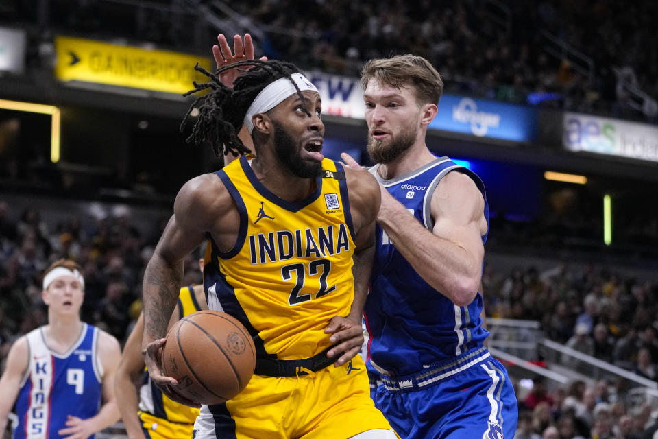 Sacramento Kings forward Domantas Sabonis (10)] defends Indiana Pacers forward Isaiah Jackson (22) during the second half of an NBA basketball game in Indianapolis, Friday, Feb. 2, 2024. (AP Photo/Michael Conroy)