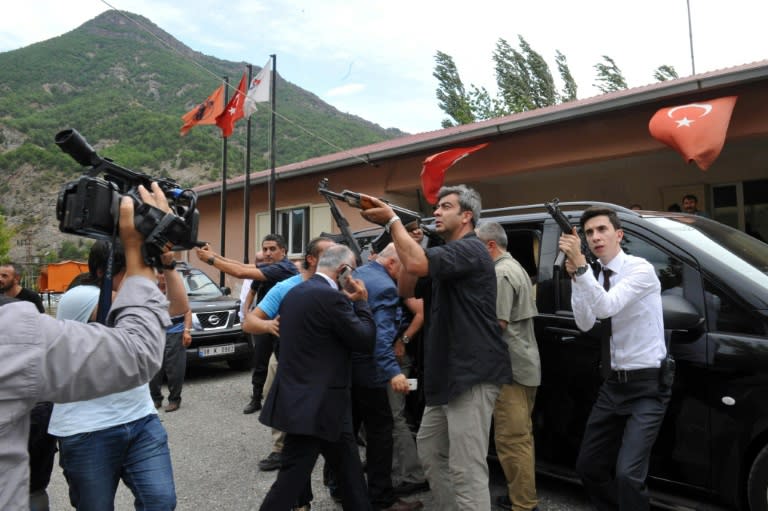 A photo released by Turkey's Republican People's Party (CHP) shows security officials protecting party leader Kemal Kilicdaroglu (C) after his convoy was attacked by Kurdish militants on August 25, 2016