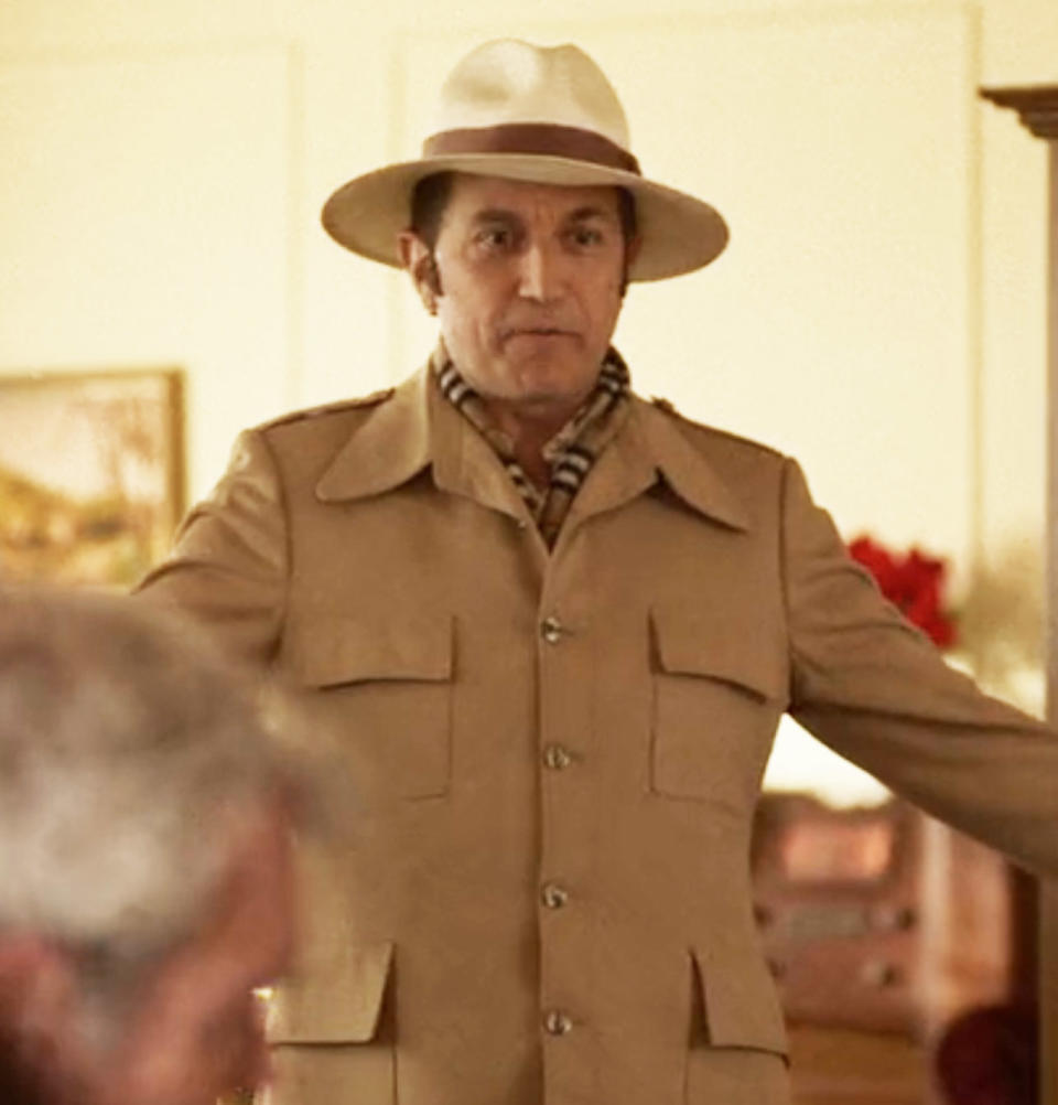 Close-up of Ian in a brimmed hat and scarf