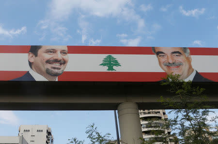A poster depicting LebanonÕs Prime Minister Saad al-Hariri, who has resigned from his post, and his father, Rafik al-Hariri, is seen in the mainly Sunni Beirut neighbourhood of Tariq al-Jadideh in Beirut, Lebanon November 6, 2017. REUTERS/Mohamed Azakir