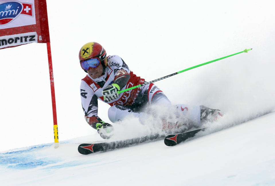 Austria's Marcel Hirscher speeds down the course during the first run of an alpine ski men's World Cup giant slalom in St. Moritz, , Switzerland, Sunday, Feb. 2, 2014. (AP Photo/Pier Marco Tacca)