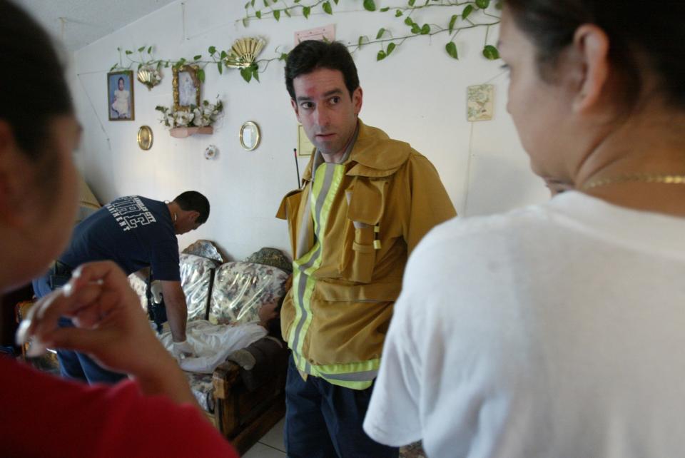 An emergency medical technician examines a girl hit by a car in South Central Los Angeles, as Marc Eckstein, EMS medical director for L.A. County, talks to her parents on Nov. 21, 2002. Eckstein is trying to improve the overall quality of EMS in Los Angeles.  