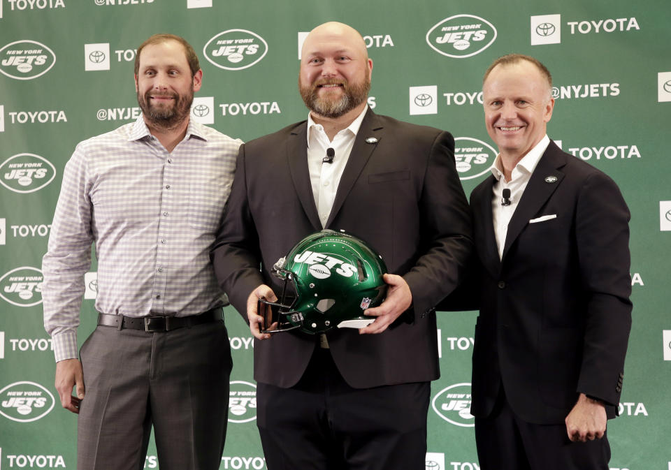 The new New York Jets general manager Joe Douglas, center, poses for a picture with head coach Adam Gase, left, and owner Christopher Johnson during a news conference at the team's NFL football training facility in Florham Park, N.J., Tuesday, June 11, 2019. (AP Photo/Seth Wenig)