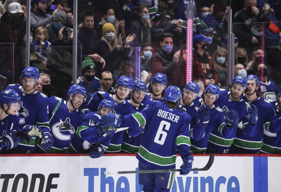 Vancouver Canucks' Brock Boeser (6) is congratulated for his shootout goal against the Florida Panthers in an NHL hockey game Friday, Jan. 21, 2022, in Vancouver, British Columbia. (Darryl Dyck/The Canadian Press via AP)