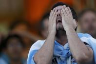 A fan of Argentina reacts while watching a broadcast of the 2014 World Cup final against Germany at the Argentine Embassy in Brasilia, July 13, 2014. REUTERS/Ueslei Marcelino (BRAZIL - Tags: SOCCER SPORT WORLD CUP)