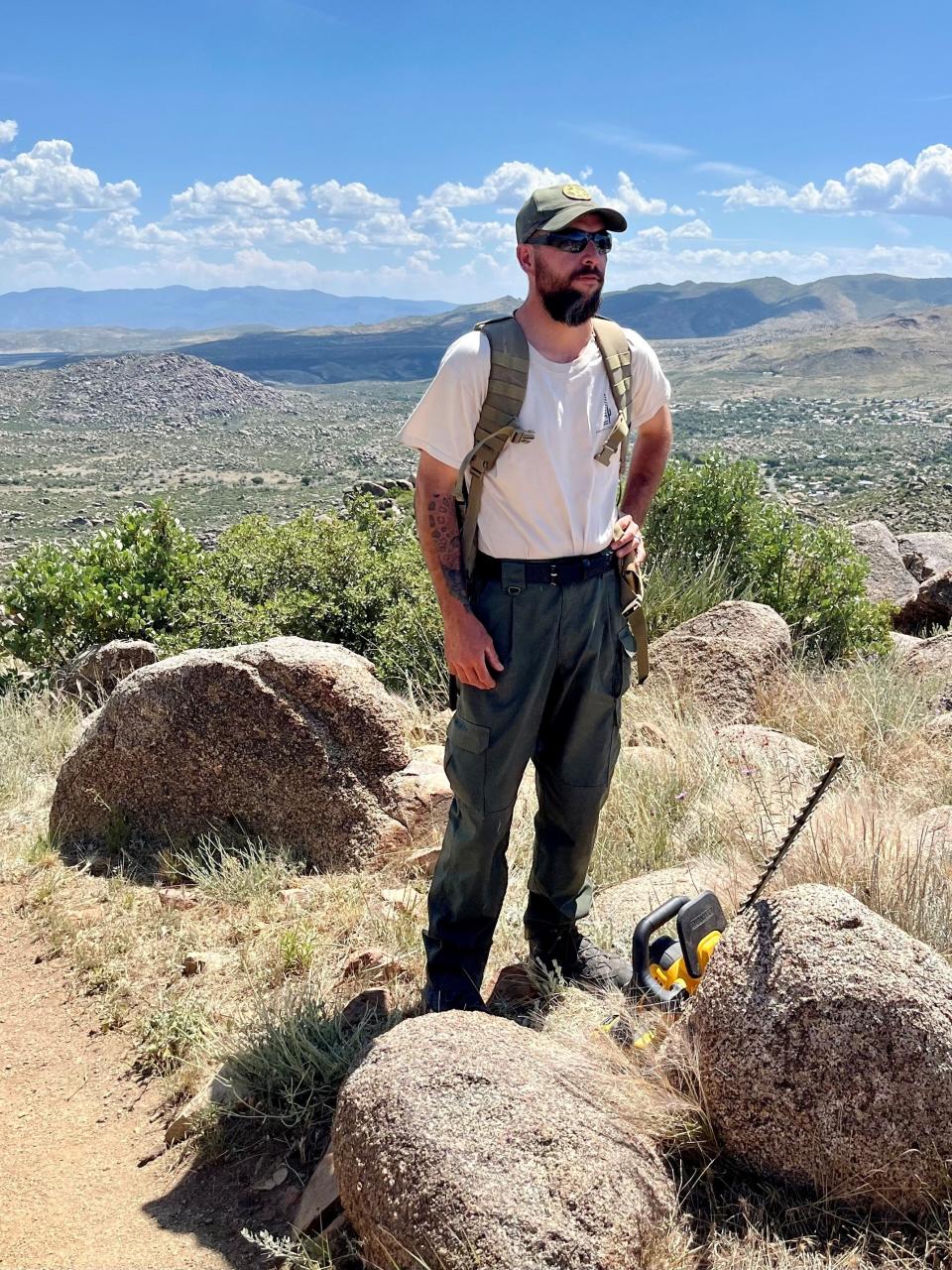 Arizona State Parks Ranger Jared Welsh pauses for a photo while doing trail maintenance on the Hotshots trail at the Granite Mountain Hotshots Memorial State Park outside of Yarnell in June 2023.