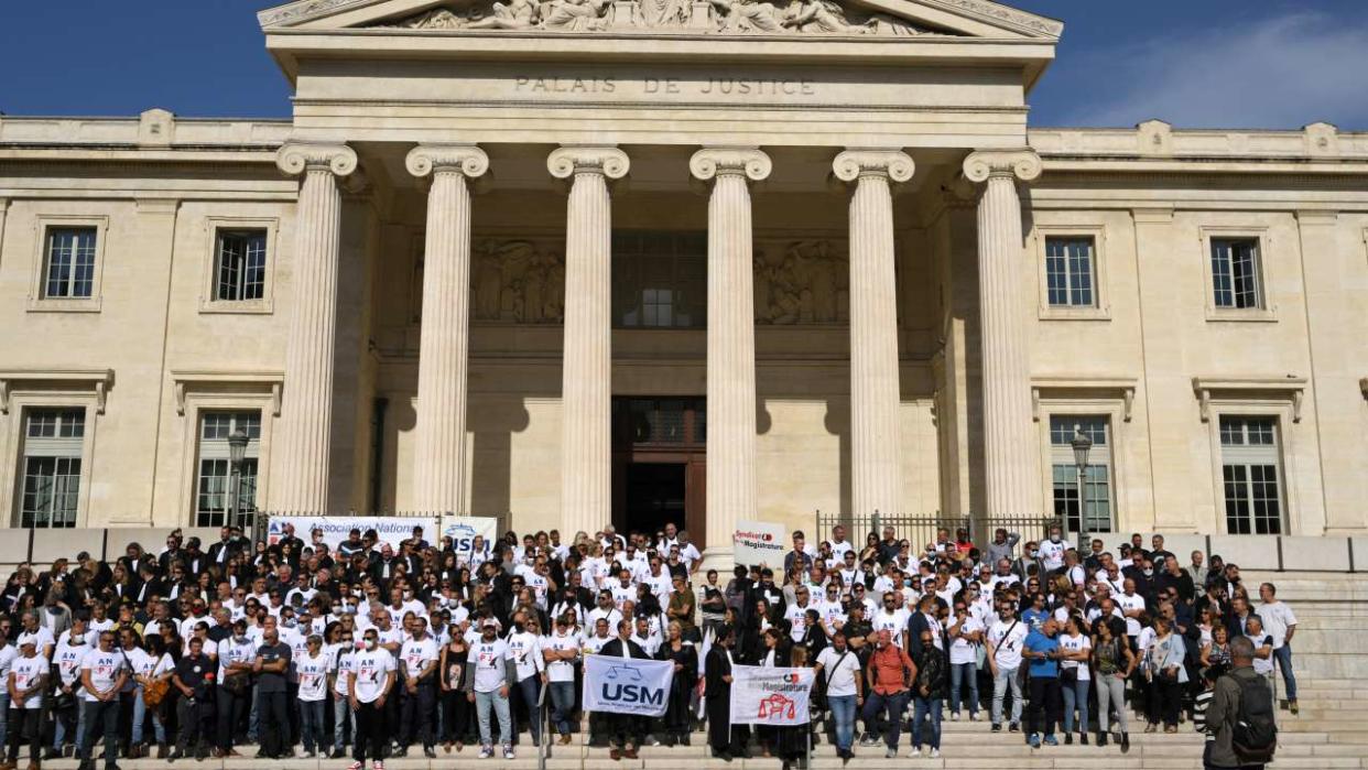 French police officers and other members of the justice system gather during a rally against the planned reform of the Judicial Police (PJ) and the recent sacking of Marseille's police chief, on the steps of the Palais de Justice in the southern city of Marseille, on October 17, 2022. - Rallies are taking place in several French cities on October 17, 2022, as opponents fear the reform would see a 'levelling down' of the Police Judicaire, in charge of the most complex crimes and investigations. (Photo by NICOLAS TUCAT / AFP)