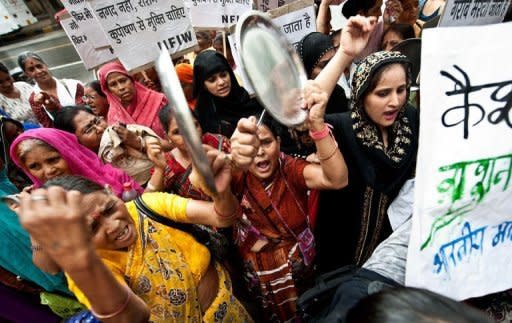 Women protest against the passage of foreign direct investment in multi-brand retail outside the Agriculture Ministry in New Delhi. The policy changes unveiled last week include allowing in foreign direct investment from retail giants such as Walmart and Tesco, as well foreign airlines