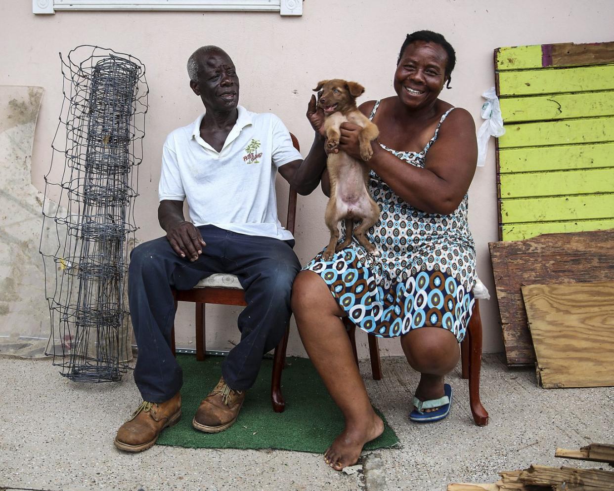 Alvin and Dorothy Nibbs with their 11-week-old puppy, Lilly, in Road Town, Tortola (Ministry of Defence/PA)