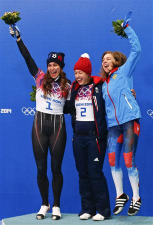 Winner Britain's Elizabeth Yarnold (C) poses with second-placed Noelle Pikus-Pace of the U.S. (L) and third-placed Russia's Elena Nikitina after the women's skeleton event at the 2014 Sochi Winter Olympics, at the Sanki Sliding Center in Rosa Khutor February 14, 2014. REUTERS/Arnd Wiegmann