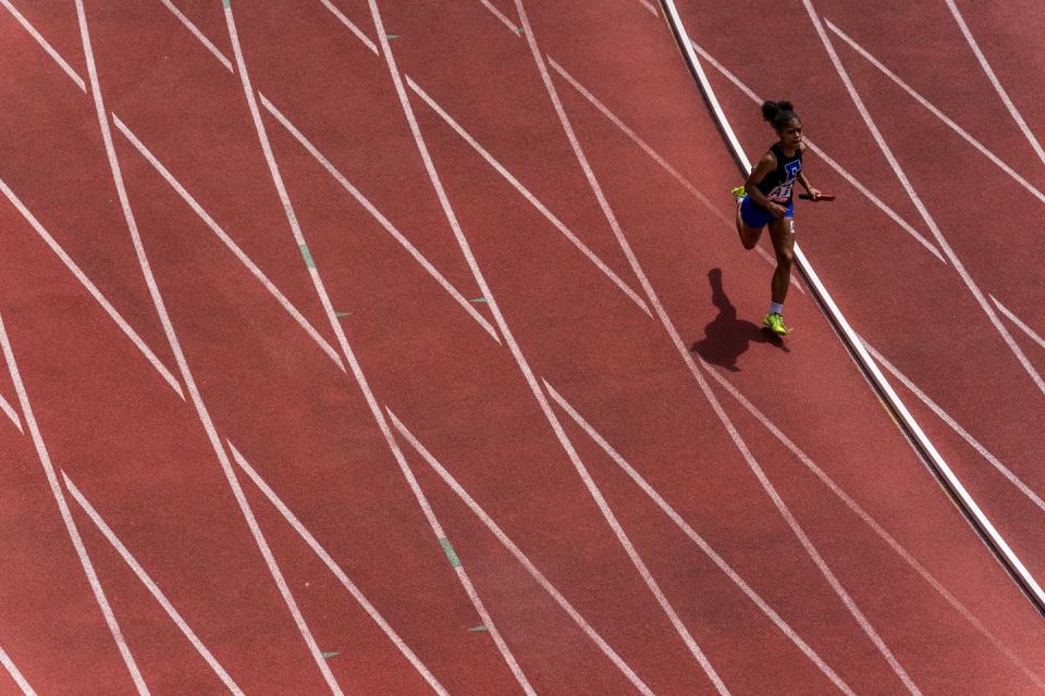 an overhead view of a single runner on a track
