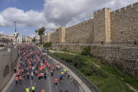 Runners compete in the Jerusalem Winner Marathon, as they run along the walls of the Old City of Jerusalem, Friday, March 8, 2024. (AP Photo/Ohad Zwigenberg)