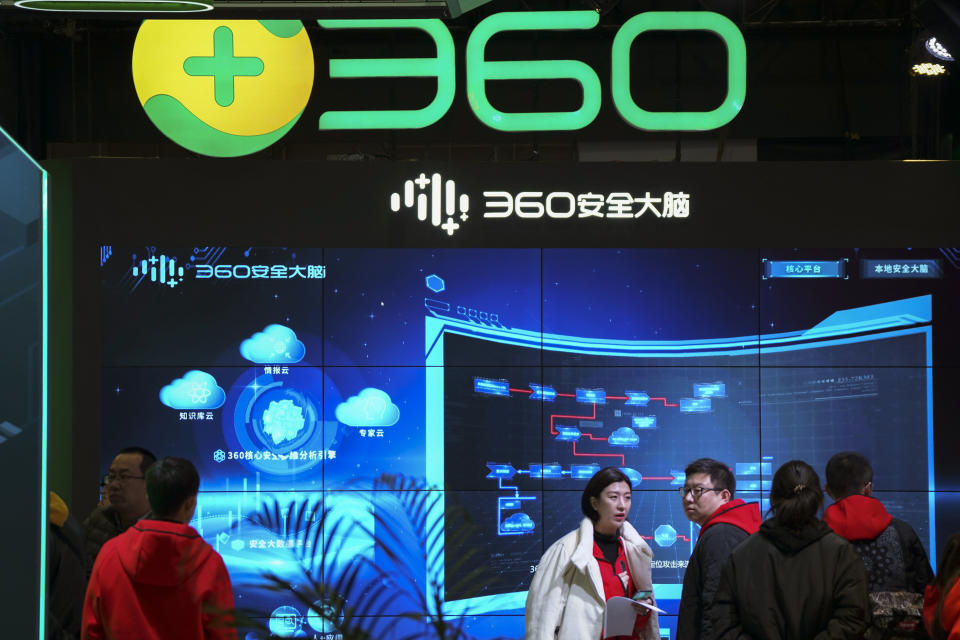 In this photo released by Xinhua News Agency, visitors tour the Chinese internet security firm Qihoo 360 showcasing it 5G digital security and protection system at the World 5G Convention in Beijing on Nov. 21, 2019. One of China's biggest tech companies has criticized the Trump administration for "politicizing business" after it slapped export sanctions on 33 more Chinese enterprises and government entities. (Li Xin/Xinhua via AP)